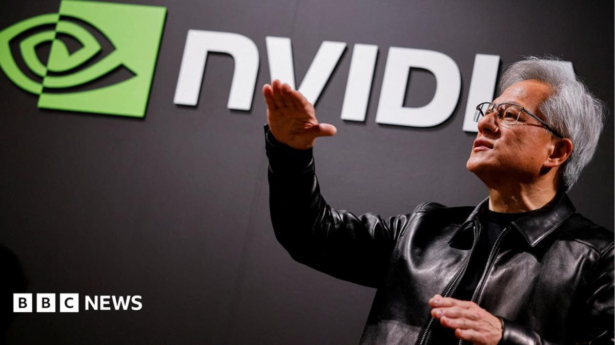 Nvidia CEO Jensen Huang standing in front of a screen with the company's name and logo, gesturing upward with his hands, wearing a black leather jacket over a black shirt.