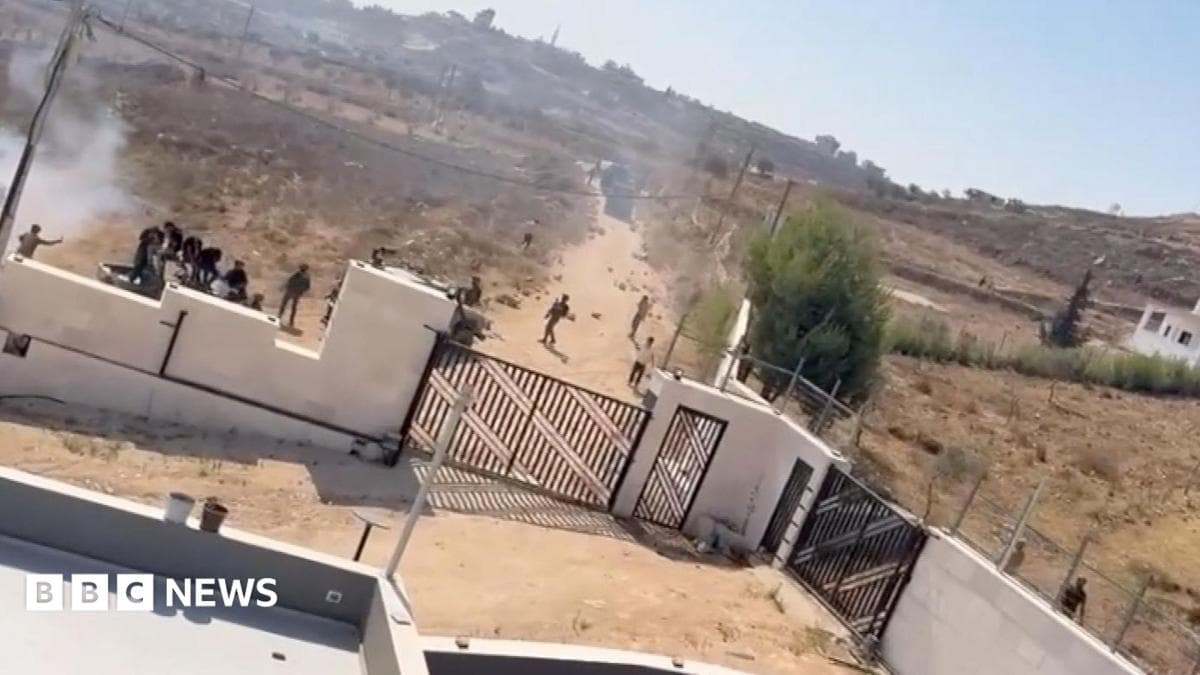 men and tear gas are seen outside ythe yard of a family home in the west bank