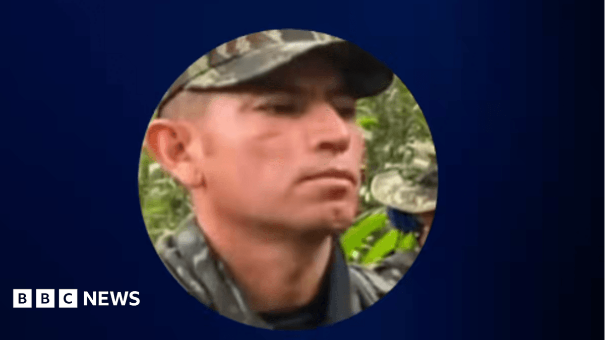 A screengrab from a video shared by Colombian President Abelardo de la Espriella shows a photo of Hernando Forero Mosquera, aka "El Ruso", accused of being a leader of a dissident Farc rebel faction. He is wearing a cap in camouflage colours and a shirt, also in camouflage colours.