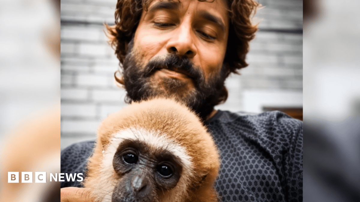 Vikram, an actor from Tamil Nadu, poses with a lar gibbon in a now-deleted video