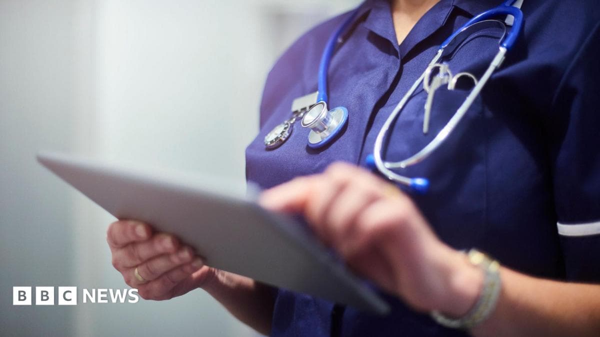 A nurse with a stethoscope holds a clipboard