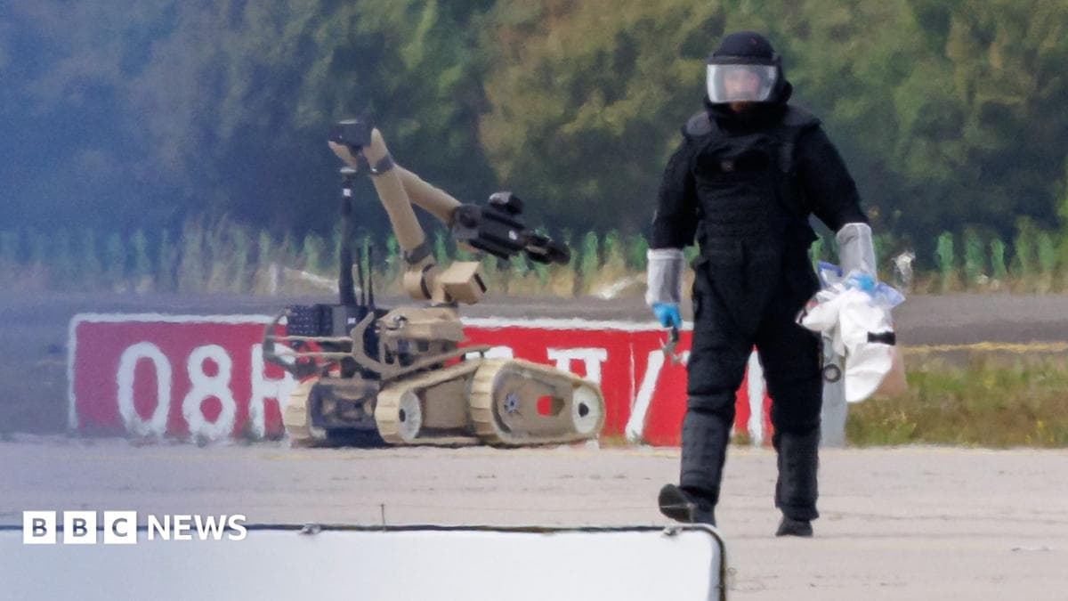 A police investigator works on the tarmac with a robot capable of defusing explosives near a Ukrainian Antonov cargo plane at Leipzig/Halle Airport on August 5, 2026 near Leipzig, Germany