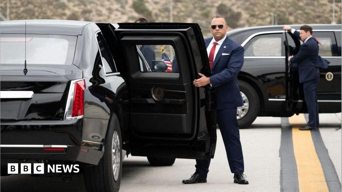 Two US Secret Service agents, both in suits, one in sunglasses, hold open the back passenger doors on two versions of the "Beast" armoured limousine.