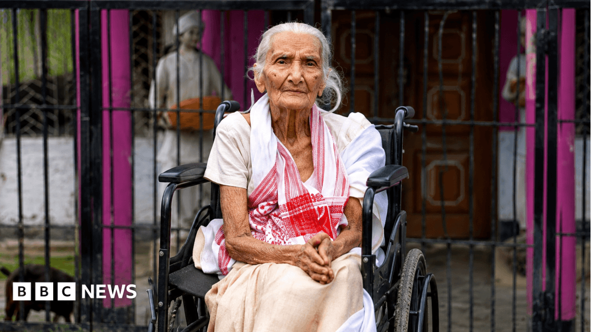 A 97-year-old Lokada Duarah was carried onto a banana tree trunk and taken to safety after floodwaters rose around her home