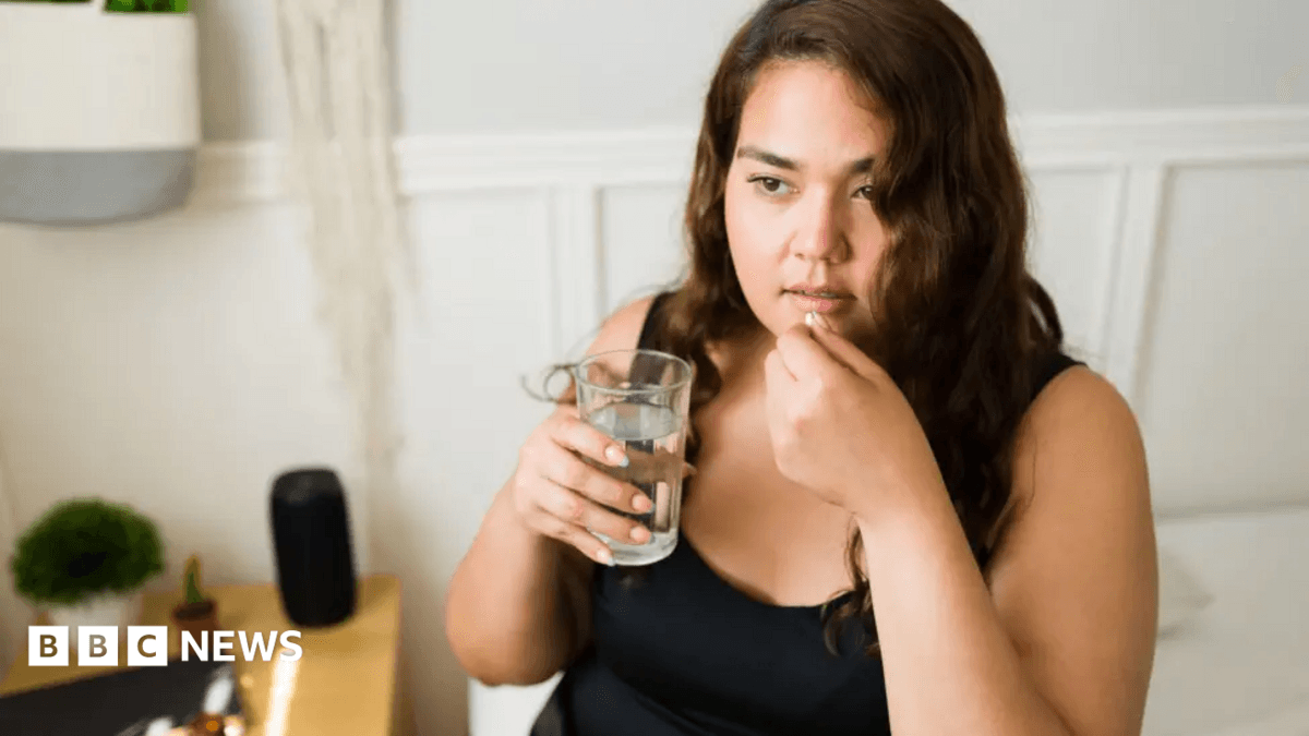 Woman taking pill