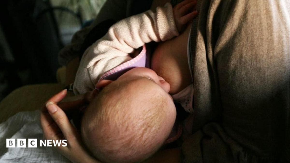 A news agency photo of a mother breastfeeding a newborn baby.
