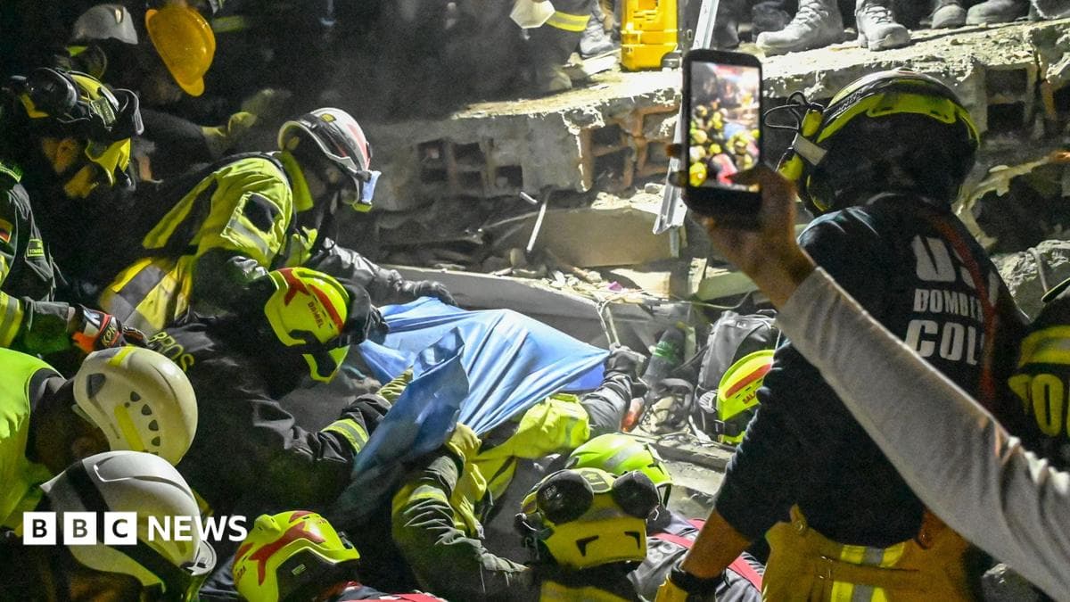 Rescue workers pull a woman from rubble in Columbia