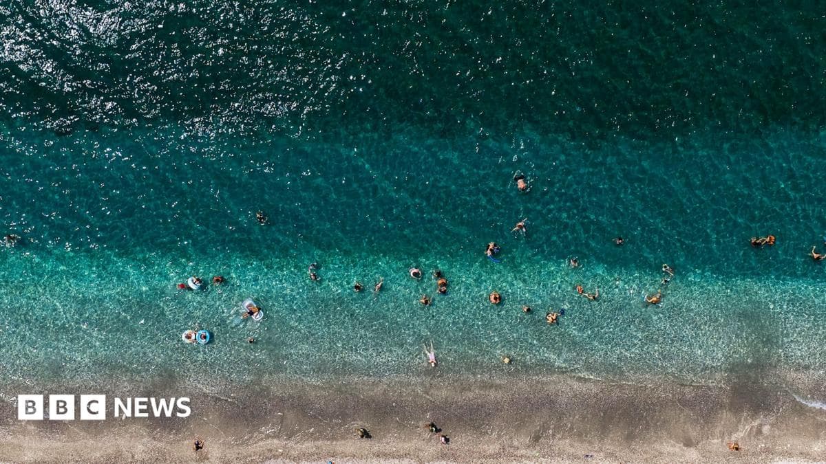 Aerial view of strip of beach in Greece and ocean