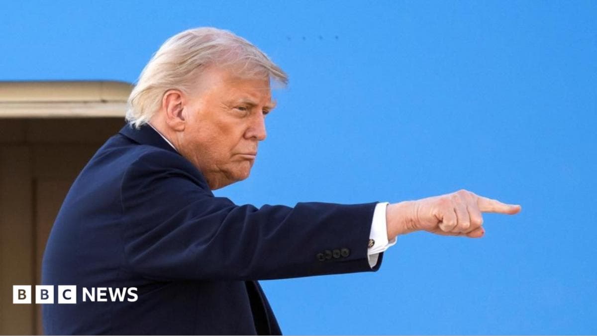 President Donald Trump gestures as he boards Air Force One