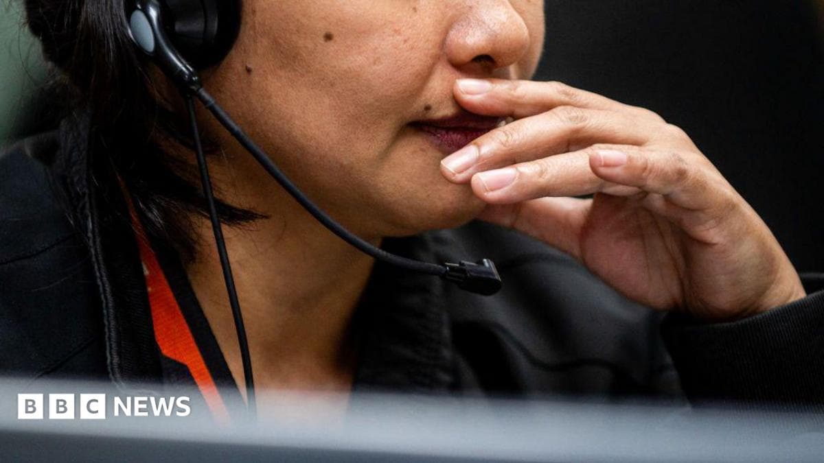 File picture of an employee speaking on the phone as she works in a Manila call centre.