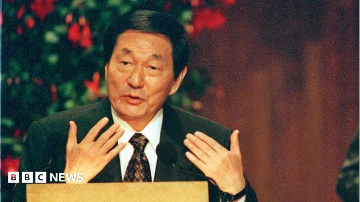 Then-Chinese Premier Zhu Rongji, wearing a suit and sitting behind a desk, giving a speech at the Massachusetts Institute of Technology in the US in 1999