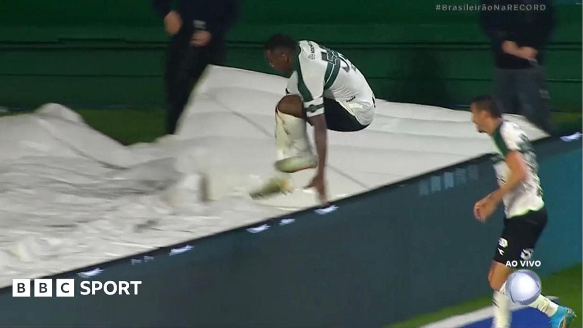 Image of Jacy Maranhao falling down a hole after jumping over the advertising boards