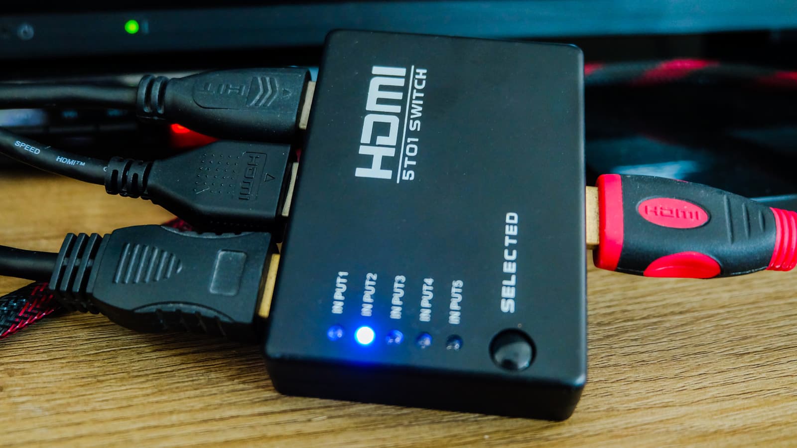 An HDMI switch on a TV stand.
